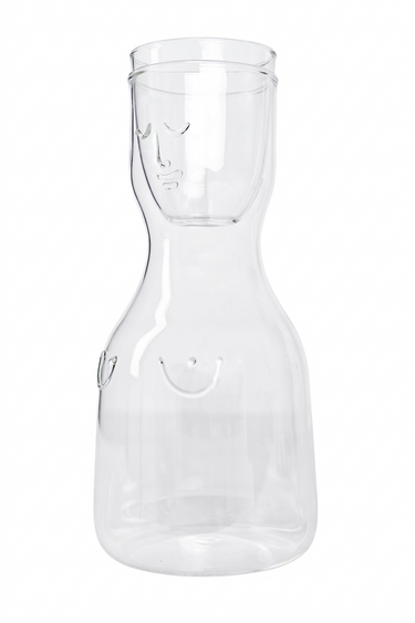 Clear glass carafe with a cup on a white background