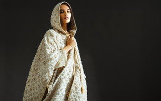 a woman is standing in a background in a studio