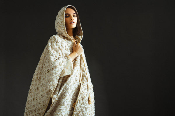 a woman is standing in a background in a studio