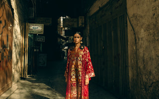 a woman is standing in a background in a studio