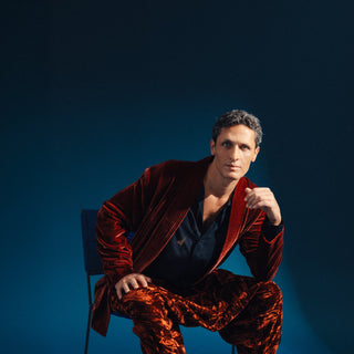 a man sitting wearing a abaya