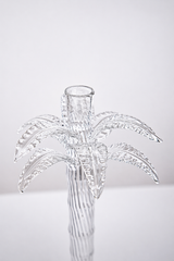 Clear glass palm tree vase on a light gray background