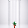 Clear glass vase with a small palm tree decoration on a white background