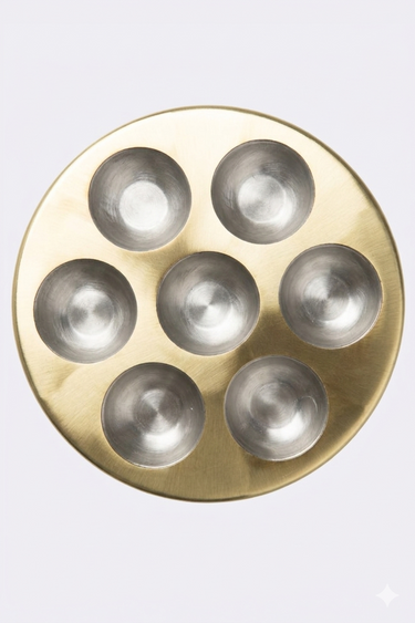 Round brass with six circular metal sockets on a white background