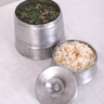 Two metal containers with food on a white surface